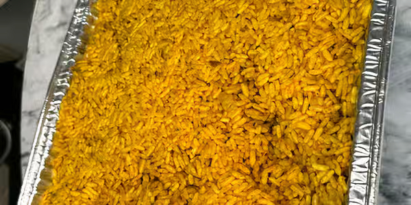 Half catering tray of party jollof rice serves 8 to 12 people at Foodsleeve